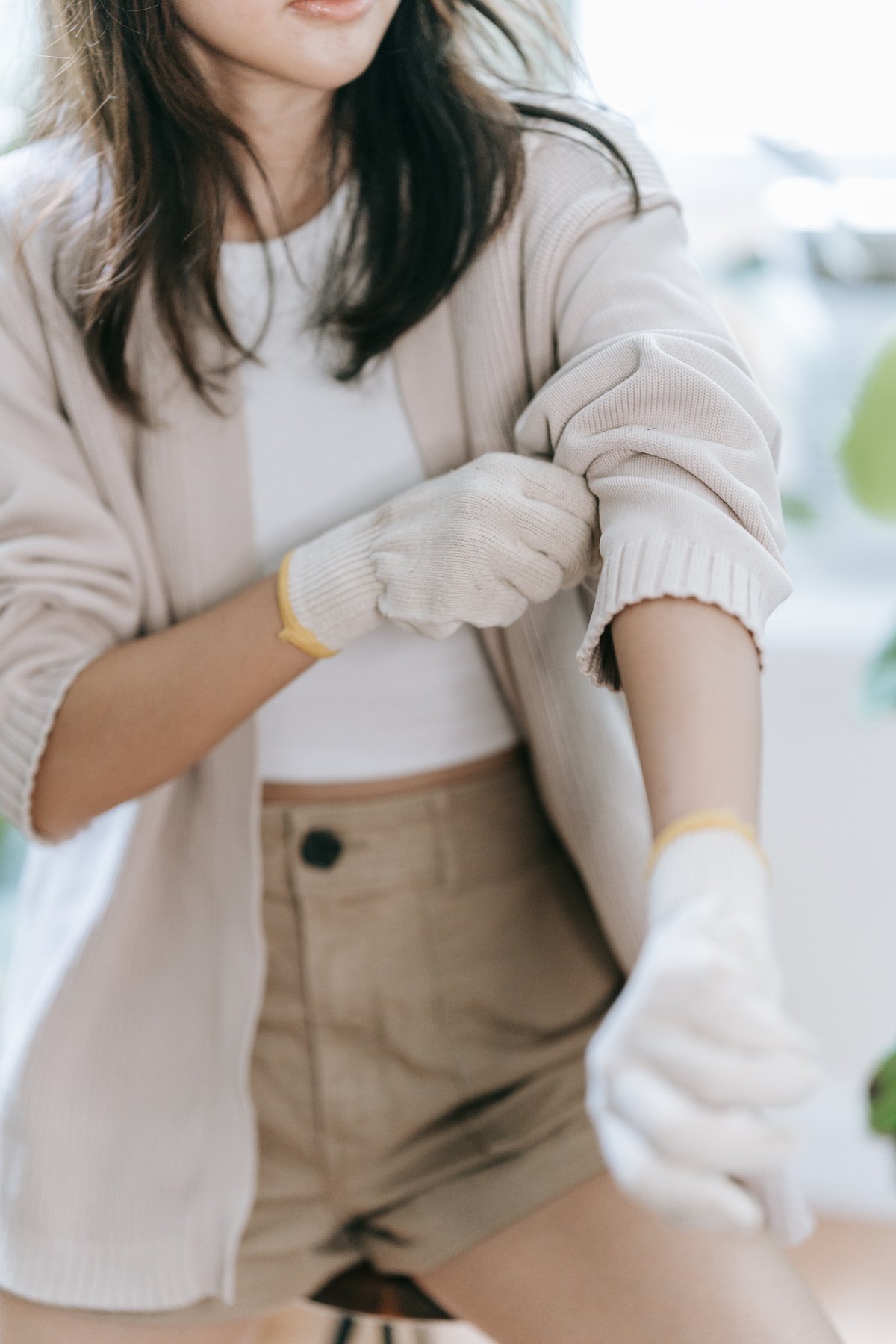 Woman Rolling Her Cardigan Sleeve 